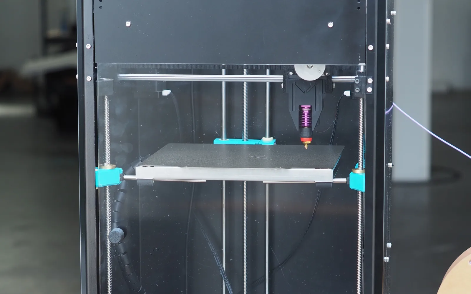 The fully enclosed aluminium frame of the Melta MK1, seen head on through the front panel